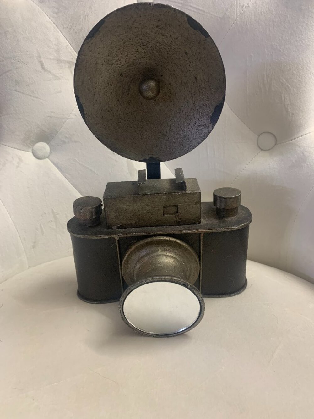 This decorative vintage-style camera sculpture features an antiqued metallic